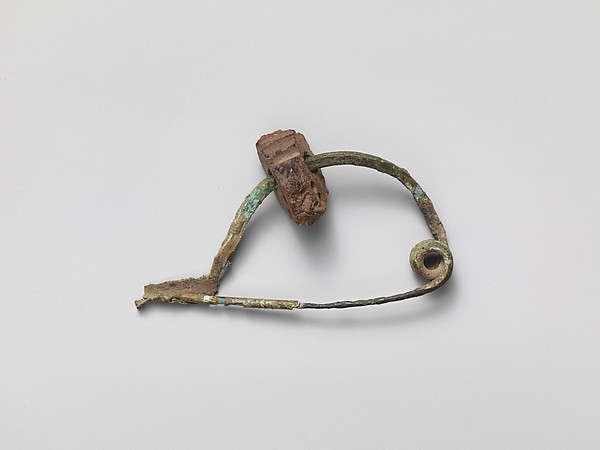 Etruscan bronze fibula set with an amber segment, amber carried south along the Amber Road